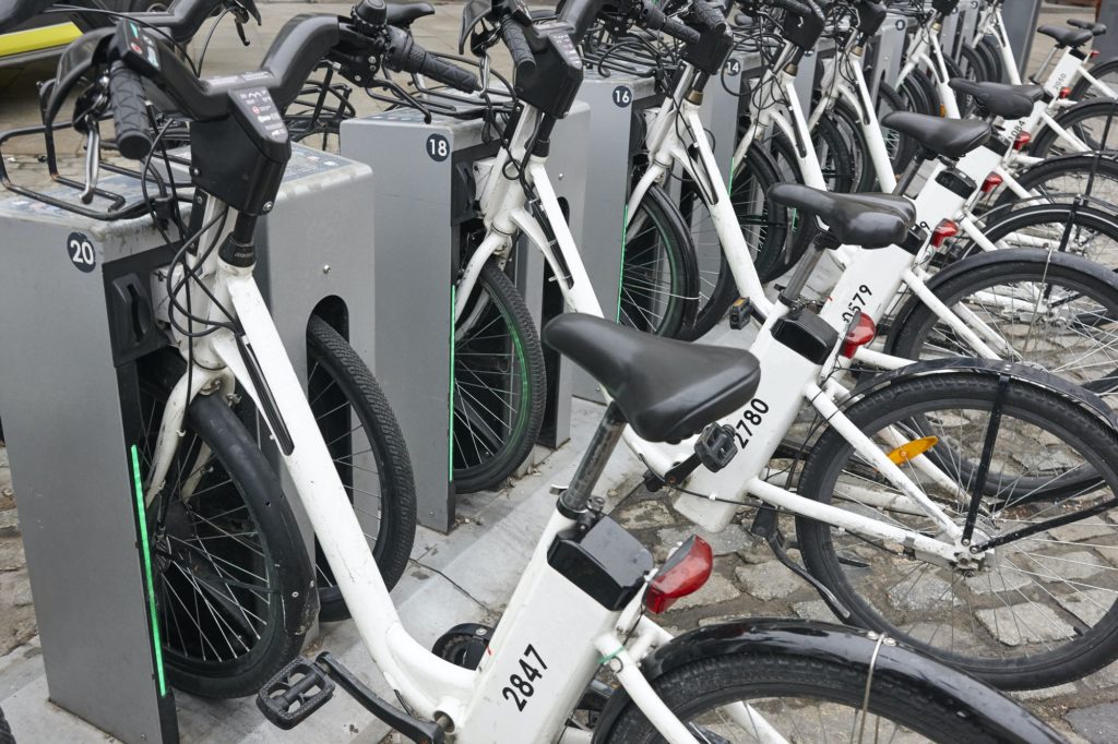 Charging electric bikes in the city. Urban green transportation. Horizontal